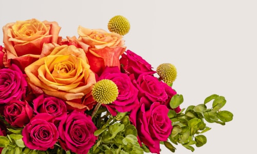 Flower arrangement consisting of pink spray roses, orange roses.